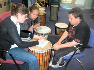 Young people working together, writing and composing short poetry pieces